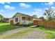 Charming single story home featuring a front porch with hanging plants and a gravel driveway at 405 N Church St, Mooresville, IN 46158