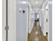 Long hallway with hardwood floors and doors leading to multiple rooms at 405 N Church St, Mooresville, IN 46158