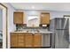 Bright kitchen featuring stainless steel appliances, wood cabinets, a double sink, and a window view at 405 N Church St, Mooresville, IN 46158