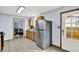 Spacious kitchen with tiled floors, stainless steel refrigerator, and view to living room at 405 N Church St, Mooresville, IN 46158