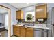 Kitchen featuring stainless steel appliances, wood cabinets, a double sink, and a window view at 405 N Church St, Mooresville, IN 46158