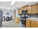 Well-lit kitchen with stainless steel appliances, wooden cabinets, a mosaic backsplash, and a breakfast nook at 405 N Church St, Mooresville, IN 46158