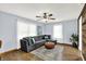 Cozy living room with a large sectional sofa, wood floors, and bright natural light at 405 N Church St, Mooresville, IN 46158