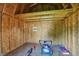 Inside the shed, find ample storage space with a lawn mower and various gardening tools at 405 N Church St, Mooresville, IN 46158