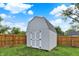 A storage shed, enclosed by fencing, offers extra storage in the home's well-kept backyard at 405 N Church St, Mooresville, IN 46158