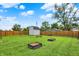 A shed stands in the backyard behind wooden fencing, offering potential storage space at 405 N Church St, Mooresville, IN 46158