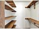 Walk-in closet featuring wood shelves with support brackets and a clothes rod for ample storage at 405 N Church St, Mooresville, IN 46158