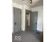 Bedroom with carpet, two gray doors, and neutral paint with gray trim at 416 W 21St St, Anderson, IN 46016