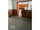 Dining room leading to the kitchen, featuring wood paneling and neutral carpeting at 416 W 21St St, Anderson, IN 46016