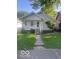 Traditional one-story home featuring a cozy front porch and mature landscaping at 416 W 21St St, Anderson, IN 46016
