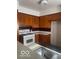 Kitchen featuring wood cabinets, a white stove, and ample storage space at 416 W 21St St, Anderson, IN 46016