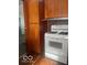 Kitchen featuring wood cabinets, white stove, and ample cabinet space at 416 W 21St St, Anderson, IN 46016