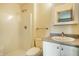 Clean bathroom with a shower, toilet, and vanity with granite countertop at 4309 Clayburn Dr, Indianapolis, IN 46268