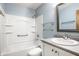Updated bathroom features a white vanity, framed mirror, a shower and tub combination, offering a modern space at 4309 Clayburn Dr, Indianapolis, IN 46268