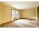 Bright, carpeted bedroom with a large window offering natural light at 4309 Clayburn Dr, Indianapolis, IN 46268