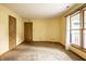Sunlit bedroom with plush carpeting, a window providing ample natural light, and two closets at 4309 Clayburn Dr, Indianapolis, IN 46268
