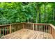 Spacious wooden deck perfect for outdoor entertaining or relaxing amidst lush greenery and serene surroundings at 4309 Clayburn Dr, Indianapolis, IN 46268