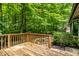 Charming wooden deck surrounded by lush greenery offers a serene space for relaxation and outdoor enjoyment at 4309 Clayburn Dr, Indianapolis, IN 46268