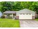 Charming single-story home with a well-manicured lawn and an attached two-car garage at 4309 Clayburn Dr, Indianapolis, IN 46268