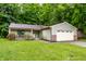 Charming single-story home with a well-manicured lawn and an attached two-car garage at 4309 Clayburn Dr, Indianapolis, IN 46268