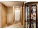 Inviting hallway featuring a decorative glass display case and neutral wall tones at 4309 Clayburn Dr, Indianapolis, IN 46268