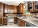 Well-appointed kitchen with dark cabinets, stainless steel appliances, and ample counter space at 4309 Clayburn Dr, Indianapolis, IN 46268