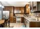 Stylish kitchen features dark cabinets, stainless steel appliances, and a tiled backsplash at 4309 Clayburn Dr, Indianapolis, IN 46268
