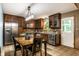 Eat-in kitchen with dark wood cabinets, stainless steel appliances, and a window above the sink at 4309 Clayburn Dr, Indianapolis, IN 46268