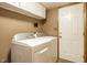 Efficient laundry room featuring modern, front-load washer and dryer units and ample cabinet storage for organization at 4309 Clayburn Dr, Indianapolis, IN 46268