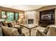 Comfortable living room featuring a tile fireplace, plush seating, and a large bay window at 4309 Clayburn Dr, Indianapolis, IN 46268