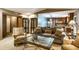 Inviting living room featuring a glass coffee table, comfortable seating, and seamless transition to the kitchen area at 4309 Clayburn Dr, Indianapolis, IN 46268