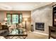 Comfortable living room featuring a tile fireplace, plush seating, and a large bay window at 4309 Clayburn Dr, Indianapolis, IN 46268