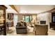 Comfortable living room with a fireplace, plush seating, and natural light from a large window at 4309 Clayburn Dr, Indianapolis, IN 46268