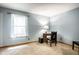 This office features a writing desk, wood floors, a window, and light blue walls, creating an inviting workspace at 4309 Clayburn Dr, Indianapolis, IN 46268