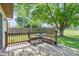 View of a wooden back deck and backyard with mature tree shading outdoor dining area at 444 Austin Dr, Avon, IN 46123