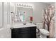 Cozy bathroom featuring a single sink vanity, toilet, and a shower with a decorative curtain at 444 Austin Dr, Avon, IN 46123