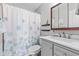 Bright bathroom with a shower-tub combo, gray vanity, and a modern marble countertop at 444 Austin Dr, Avon, IN 46123