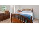 Serene bedroom featuring a bed with blue accents, a wooden dresser, and neutral carpeting at 444 Austin Dr, Avon, IN 46123