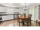 Charming dining area with hardwood floors, a round table, and views of the backyard at 444 Austin Dr, Avon, IN 46123