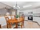Warm dining area with a wooden table set next to a kitchen with stainless steel appliances at 444 Austin Dr, Avon, IN 46123