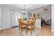 Cozy dining area with a wooden table set, chandelier, and an open view to the living room at 444 Austin Dr, Avon, IN 46123