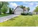 View of home with well-maintained lawn, an extended driveway, and convenient storage shed at 444 Austin Dr, Avon, IN 46123