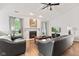 Cozy living room with a fireplace, dark leather seating, and hardwood floors at 444 Austin Dr, Avon, IN 46123