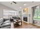 Bright, open living room with fireplace, hardwood floors, and access to the kitchen at 444 Austin Dr, Avon, IN 46123
