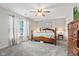 Bright main bedroom featuring a king-sized bed, plush carpet, ceiling fan, and a large window at 444 Austin Dr, Avon, IN 46123