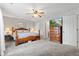Spacious main bedroom with plush carpeting, fan, and a large dresser with a television on top at 444 Austin Dr, Avon, IN 46123