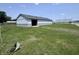 Exterior shot of home with yard, open door, and blue skies at 4503 W Minnesota St, Indianapolis, IN 46241
