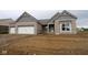 Charming single Gathering home features brick exterior, white garage doors, and architectural roofline details at 4999 Hummingbird Dr, Brownsburg, IN 46112