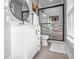 Modern bathroom featuring updated vanity, round mirror, and frameless shower with stylish tile accents at 545 Fletcher Ave, Indianapolis, IN 46203