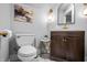 Modern bathroom with dark wood vanity, gold fixtures, and elegant marble tile flooring at 545 Fletcher Ave, Indianapolis, IN 46203